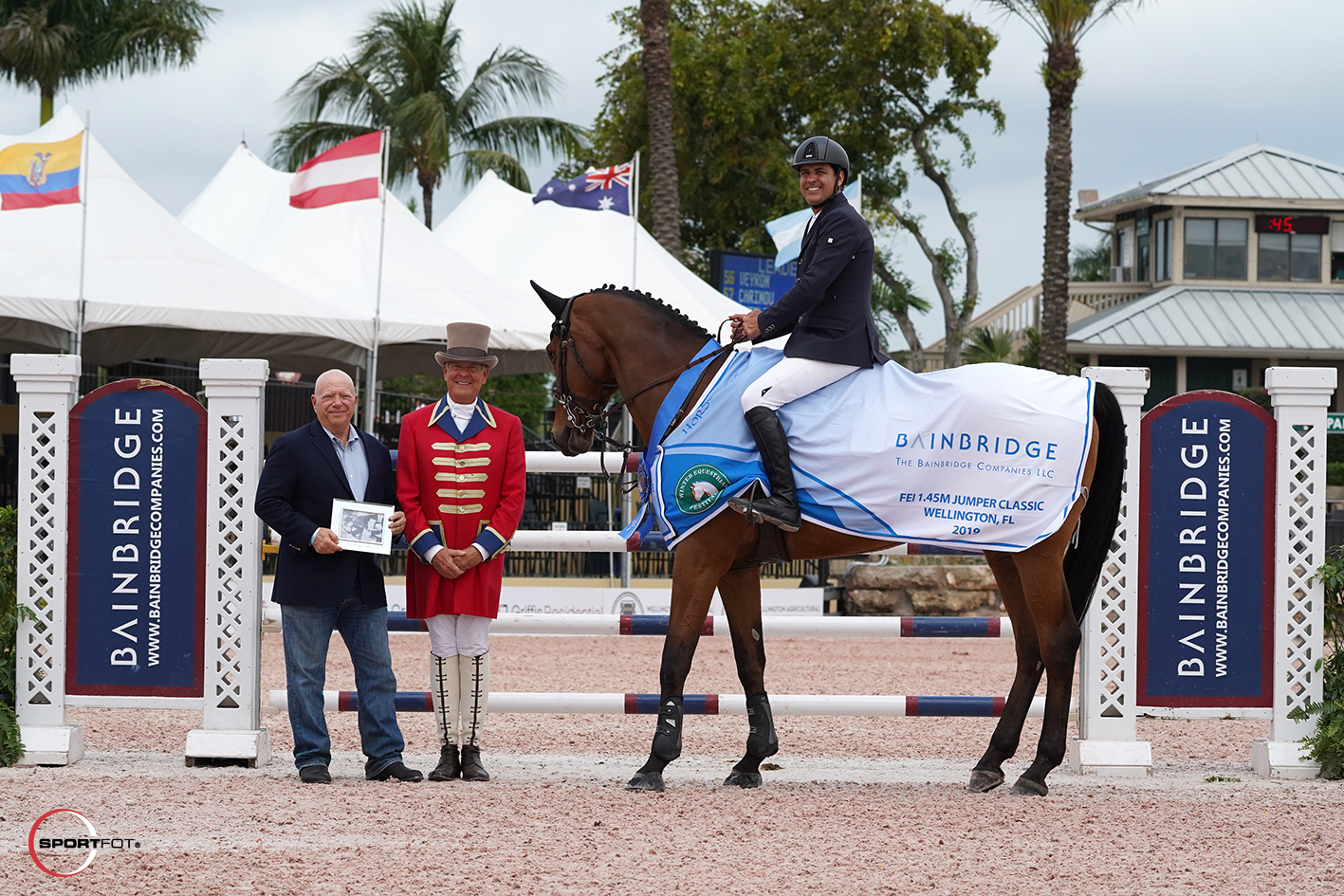 Bainbridge Chairman and CEO Richard Schechter, ringmaster Steve Rector, and Santiago Lambre. Photo © Sportfot