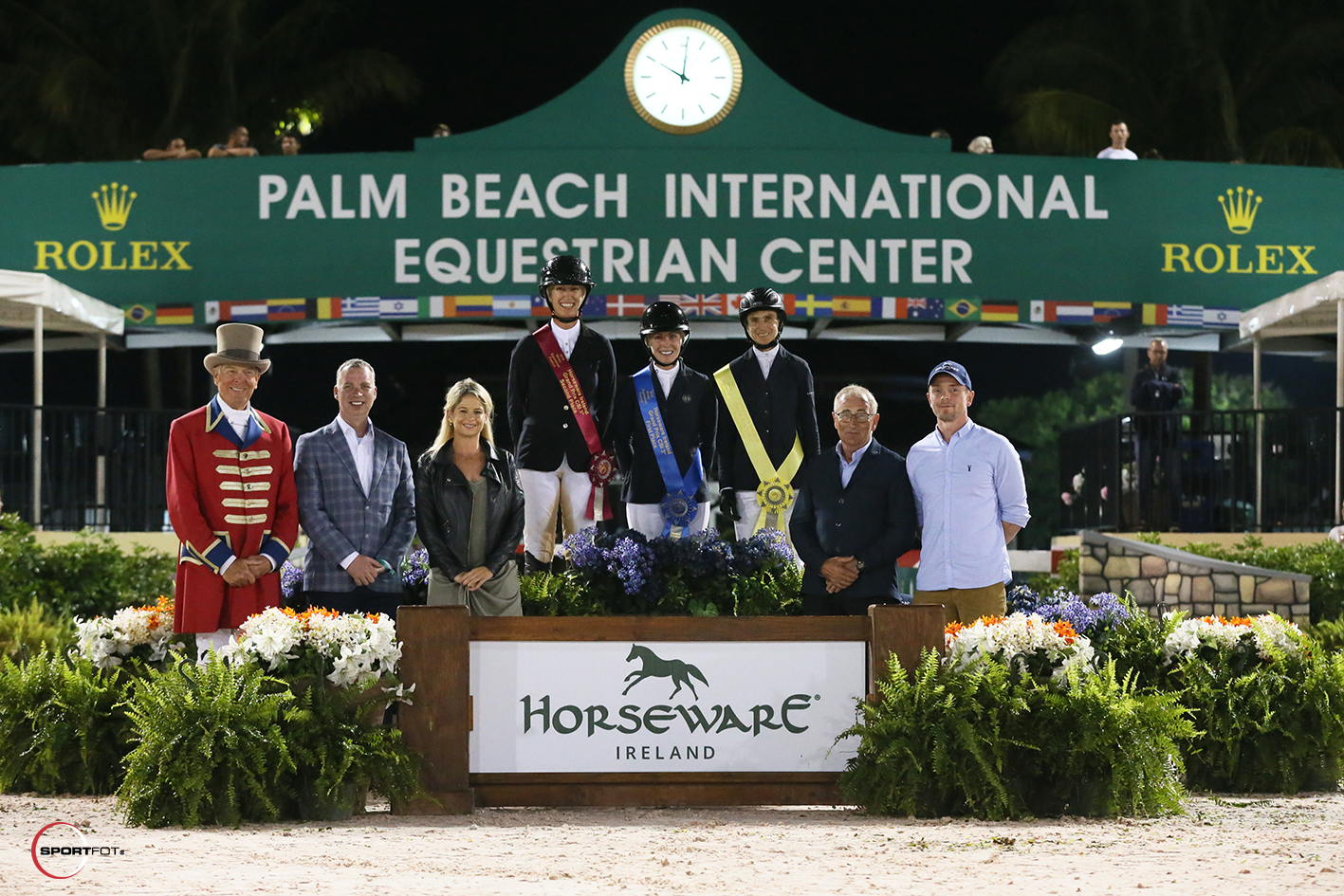 Amy Millar, Amanda Derbyshire, and Laura Chapot on the podium joined by ringmaster Steve Rector; Kelly Nicholls, VP North America; Lorraine MacGuinness, Marketing Manager; Tom MacGuinness, CEO; and Barry Finnegan, R&D, of Horseware Ireland. Photo © Sportfot