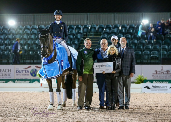 Katherine Bateson Chandler and Alcazar with Adequan®’s Allyn Mann, Equestrian Sport Productions President Michael Stone, Olga Hartsock of CaptiveOne Advisors, Carl Chandler, and judge at C Mike Osinski.