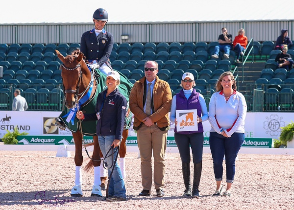 Sarah Lockman with her groom Hannah Fleming, judge Henning Lehrmann, Marcia Kulak of The Brooke USA and Wh itney Fernandes of Adequan®.