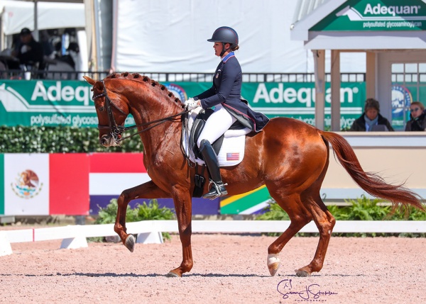 Sarah Lockman (USA) scores an emotional first international big tour victory on the 10-year-old First Apple, by Vivaldi.