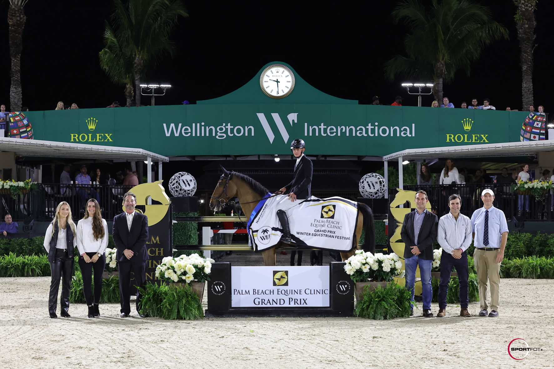 Tony Stormanns & Donjon d’Asschaut are presented as winners of the $50,000 Palm Beach Equine Clinic Grand Prix by (left to right) Dr. Michelle Maguire, Dr. Candelaria Chunco, Dr. Scott Swerdlin, Dr. Richard Wheeler, Dr. Santiago Demierre and Dr. Christopher Elliott. Photo © Sportfot